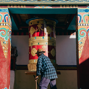Abha le spinning prayer wheel on his way back home